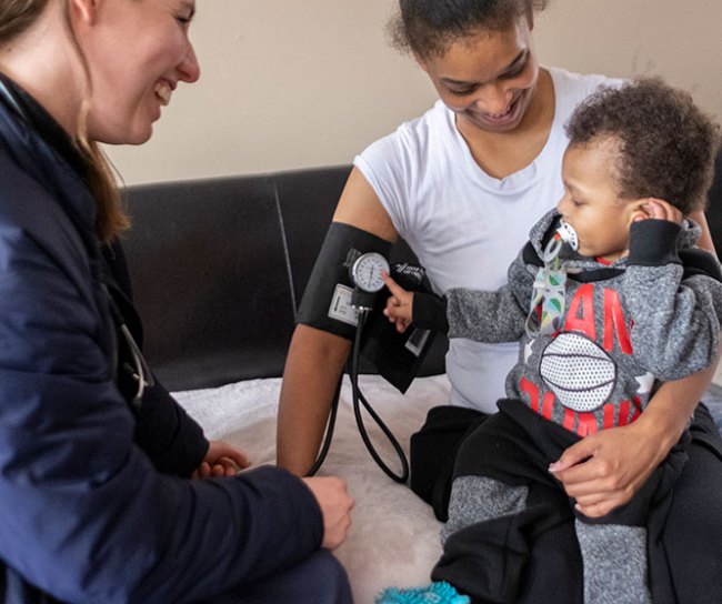 nurse checking mother and baby for blood pressure