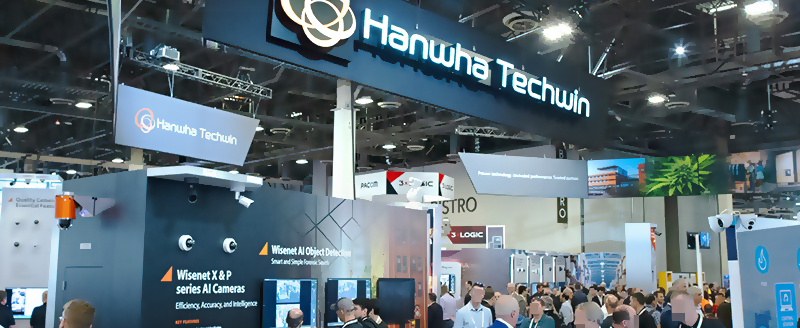ISC West 2022 attendees explore Hanwha Techwin’s display featuring AI camera and video analytics solutions